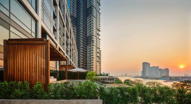 Capella Bangkok riverside garden at sunset