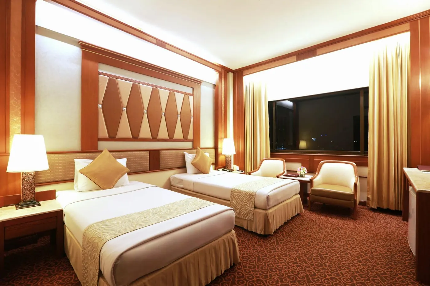 Twin room with two single beds and armchairs at Asia Hotel Bangkok