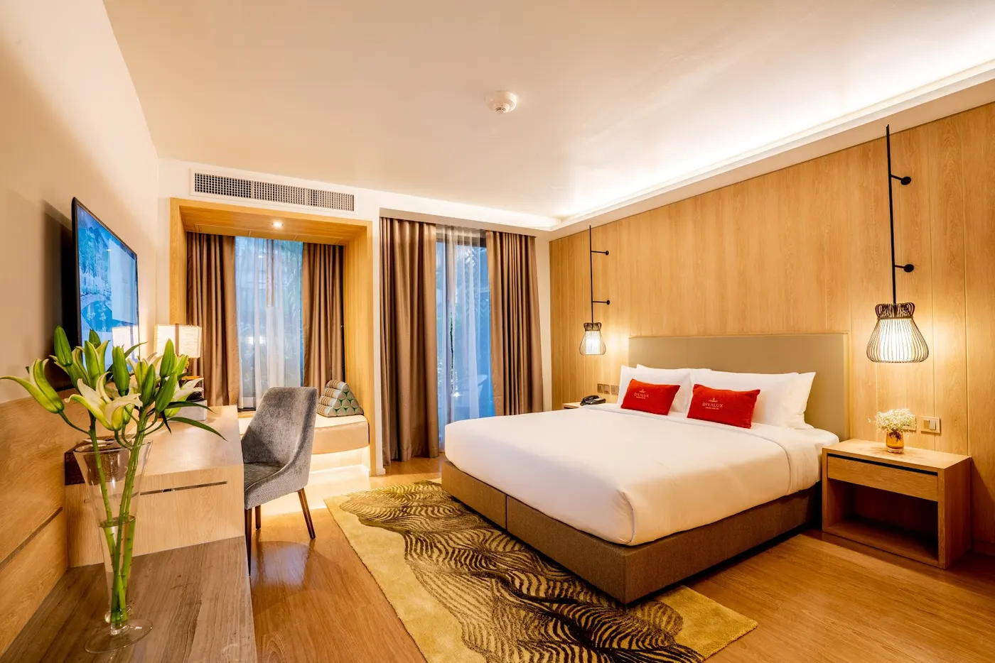 Guest room with a king bed at Divalux Resort & Spa