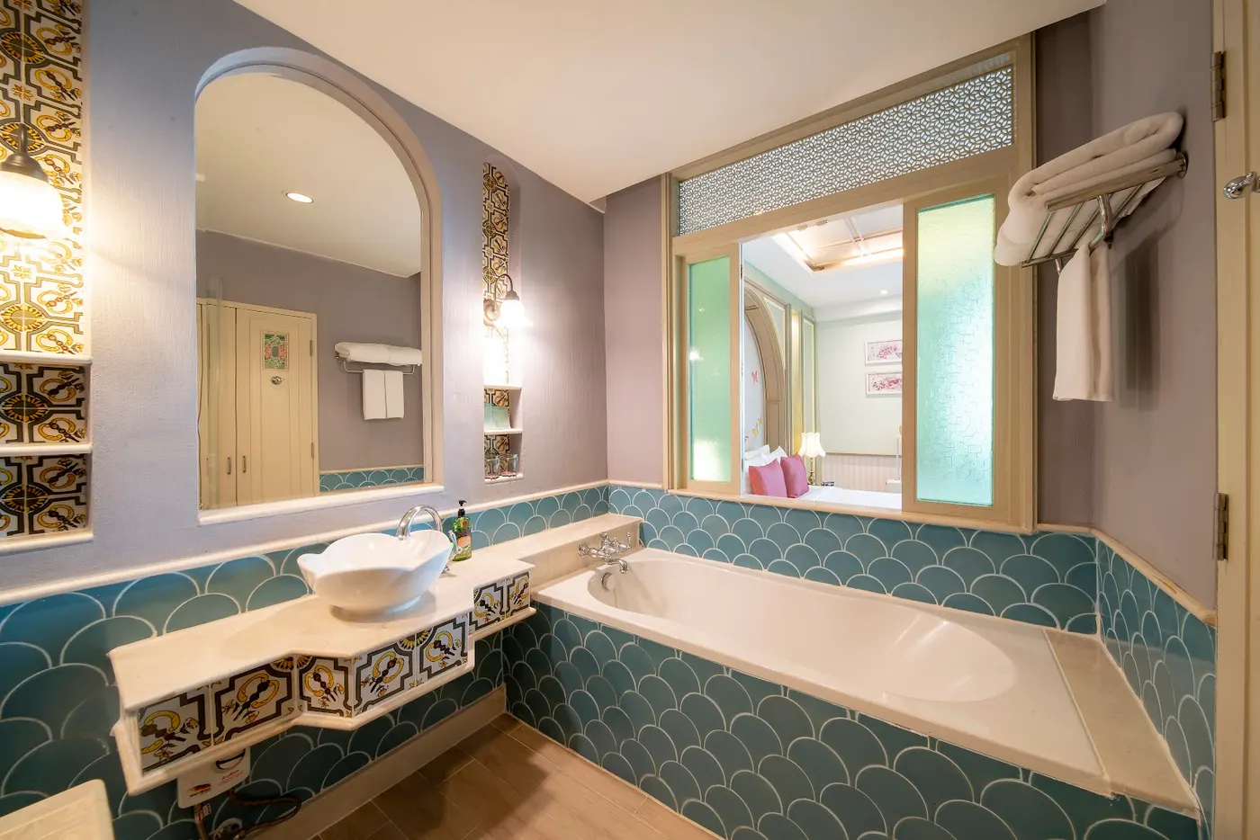 Tiled bathroom with a bathtub at La Petite Salil Sukhumvit 11