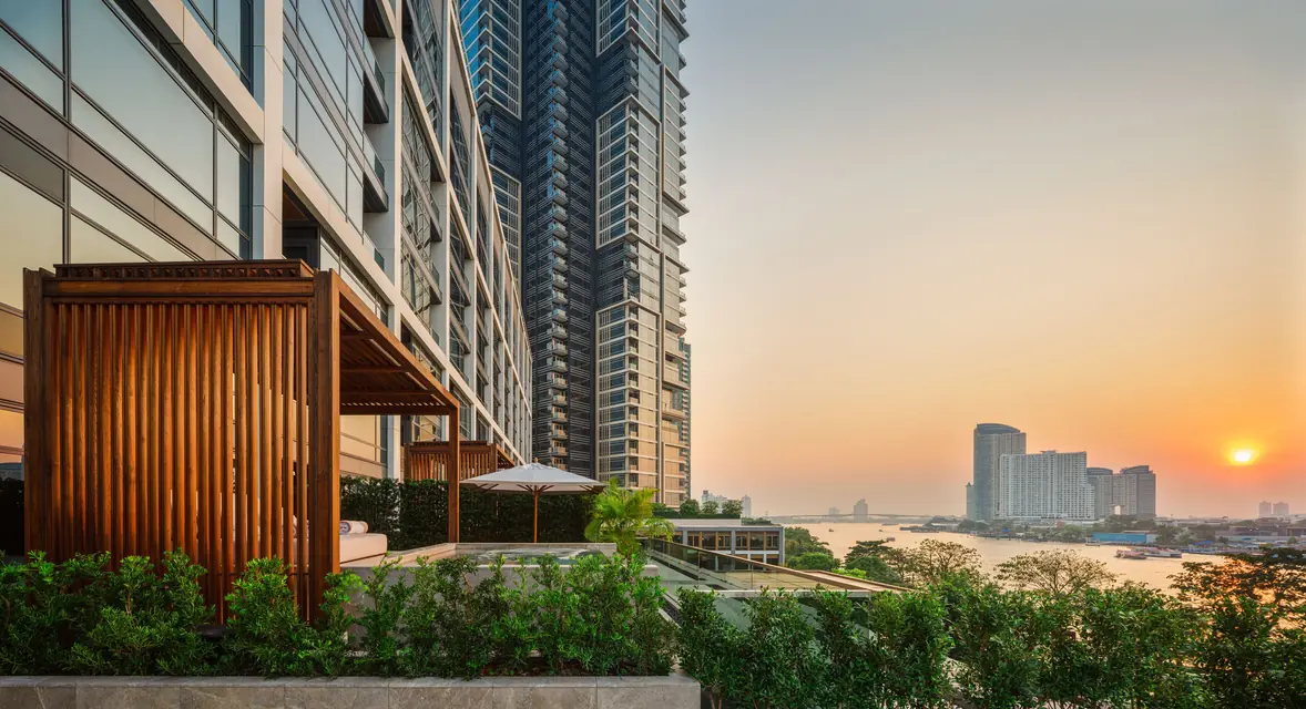 Capella Bangkok riverside garden at sunset via Expedia