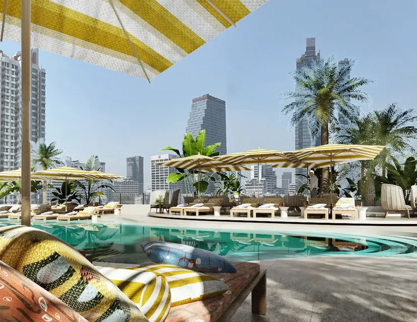 Rooftop pool with striped umbrellas at The Standard, Bangkok Mahanakhon via Expedia