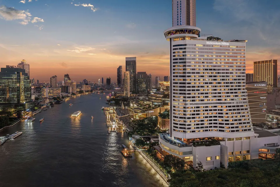 Millennium Hilton Bangkok tower on the river at sunset via Expedia