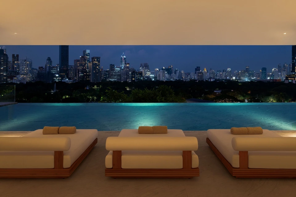 Dusit Thani Bangkok rooftop pool at night over Lumphini Park via Expedia