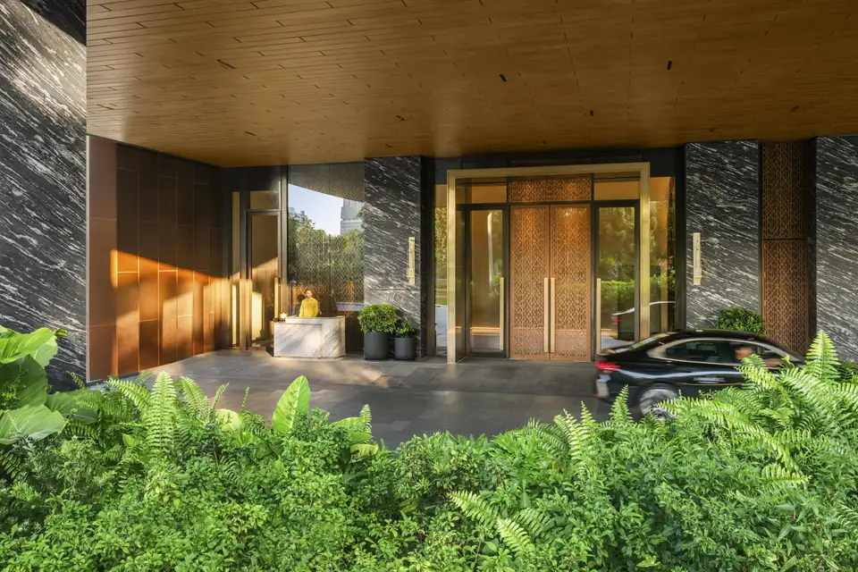 Andaz One Bangkok entrance with bronze doors and tropical planting via Expedia