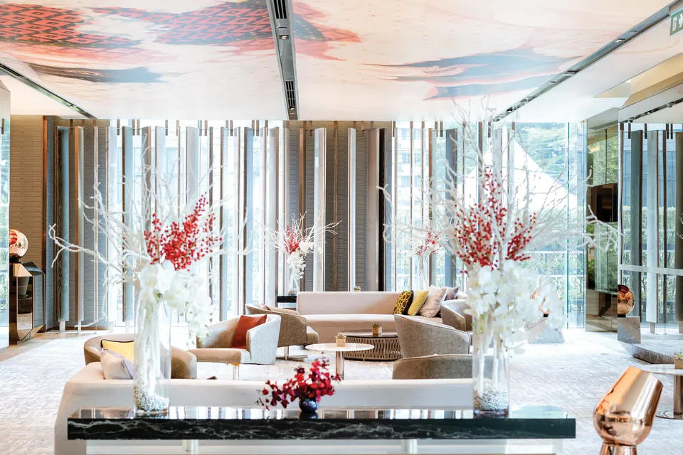 Hilton Sukhumvit Bangkok lobby lounge with tall windows via Expedia