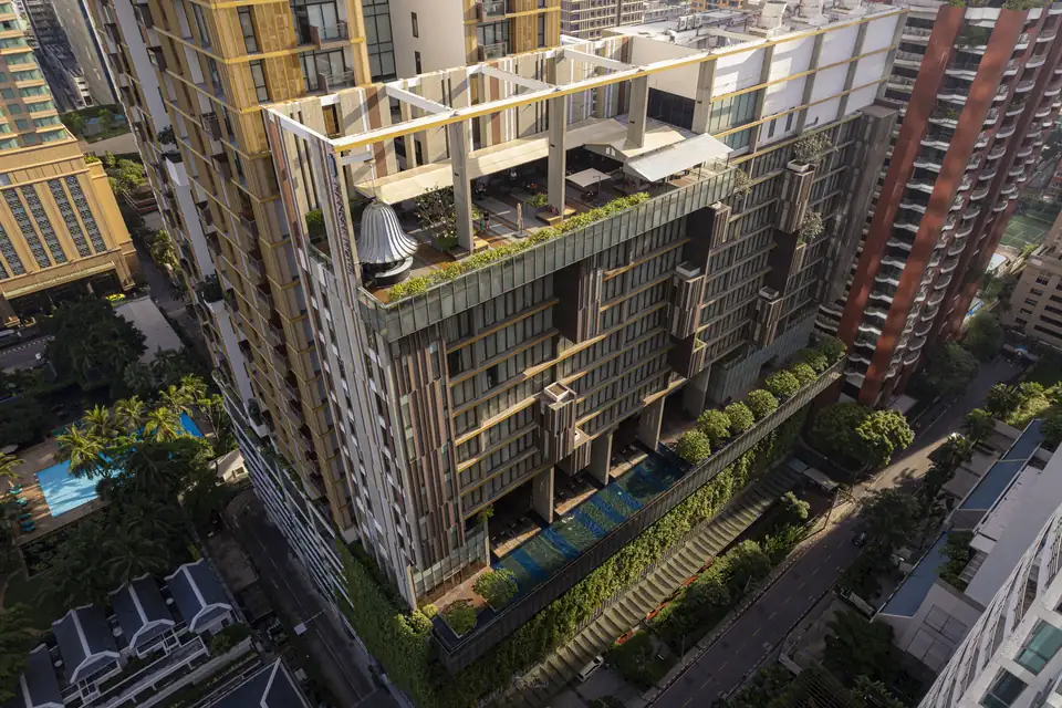 Hansar Bangkok Hotel tower with green terraces, seen from above via Expedia